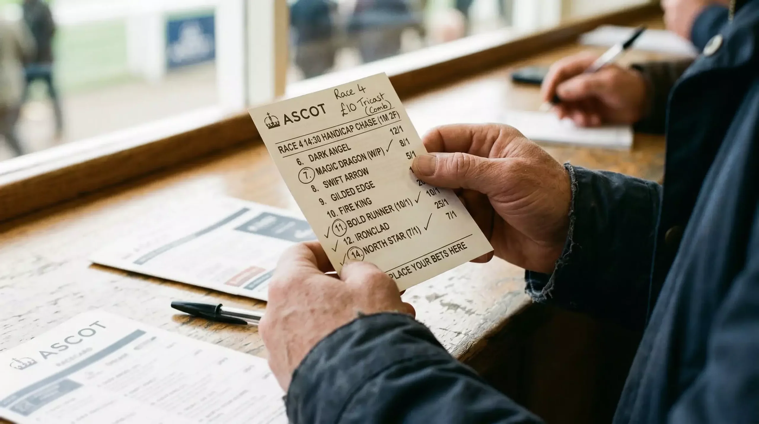Punter holding a tricast betting slip with three horse selections marked